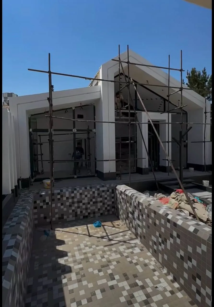 Pool Pavilion: Shell to Night-Lit Finish — before — Pool mosaic tiling in progress beside pavilion scaffolding, then finished night walkway toward the lit pavilion.