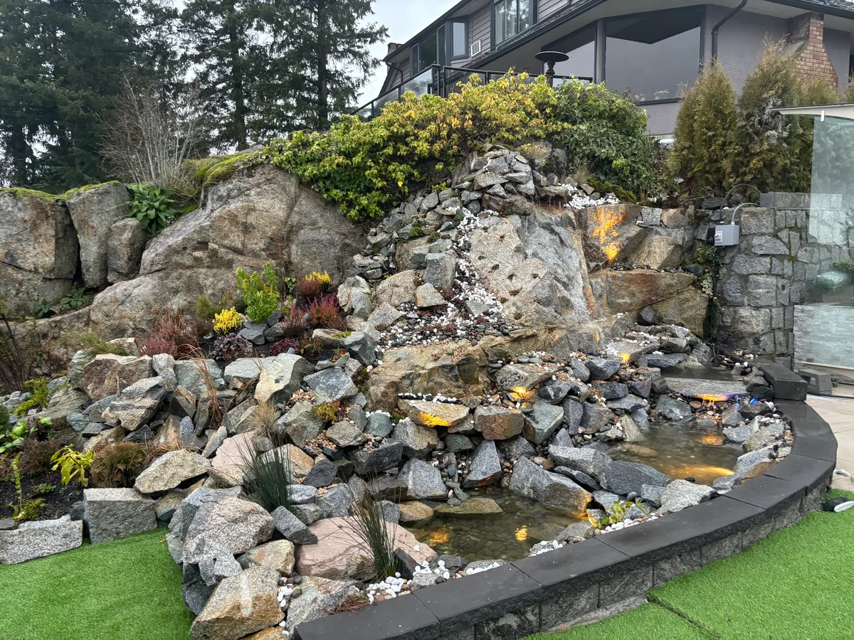 Same waterfall basin during pump and liner install, then completed multi-tier waterfall with turf edge and night lighting.